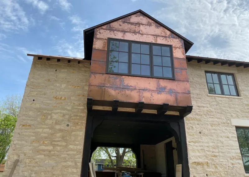 Copper metal panel facade on a stone building for Metal Roof Coating in Reminderville