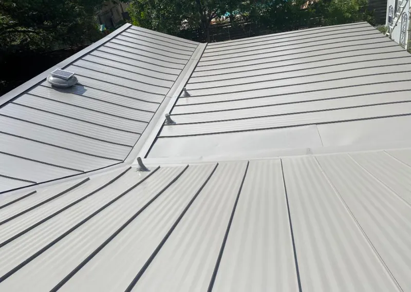 Solar attic fan installed on a metal roof for Roof Ventilation in Reminderville